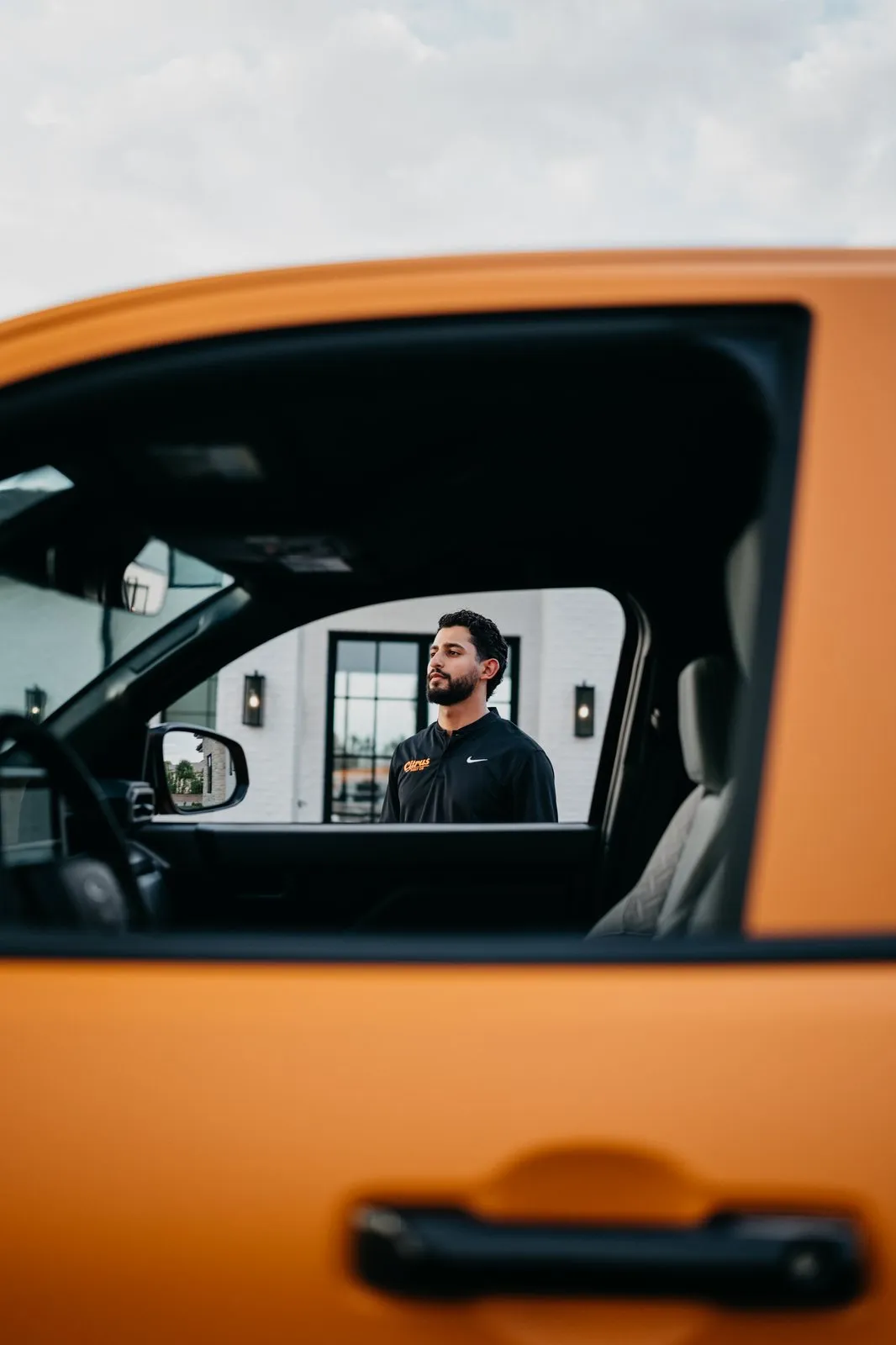 Citrus Pest Co owner beside the branded orange truck